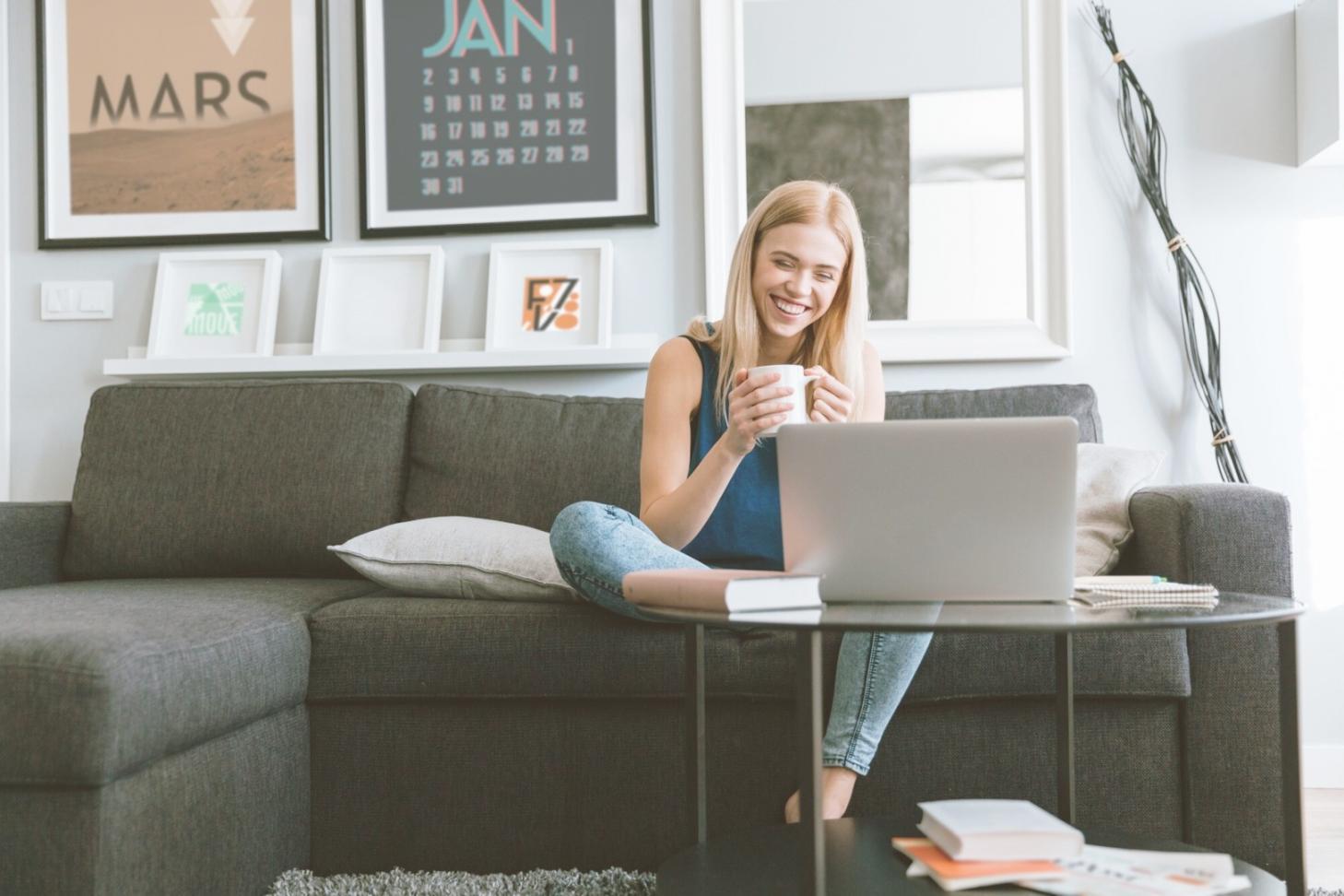 Financial documents organized on workspace with laptop showing budget analysis