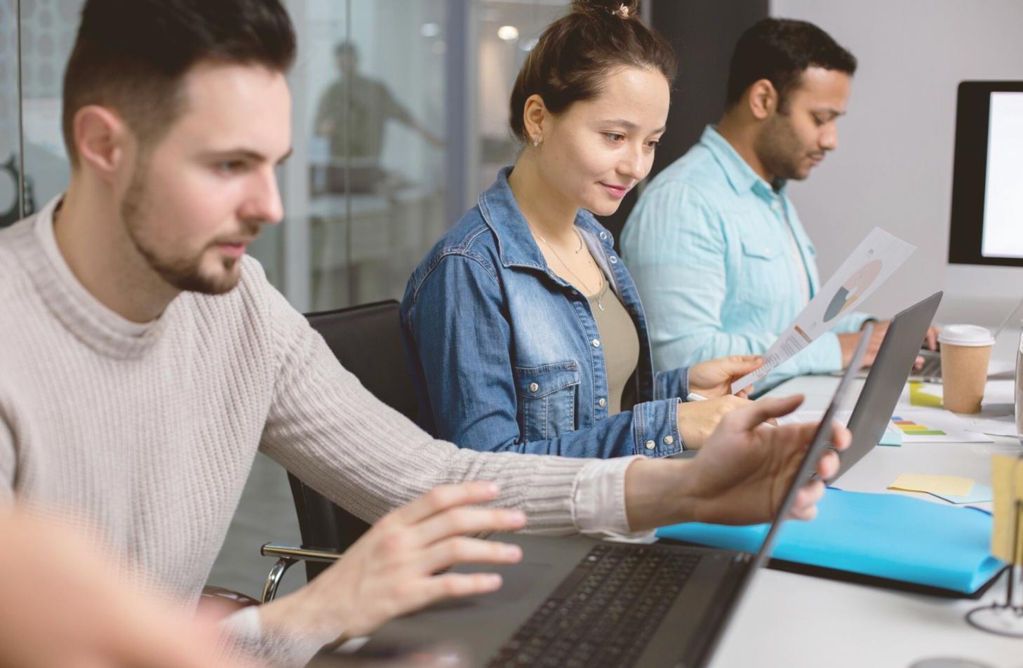 Professional reviewing financial documents with organized filing system